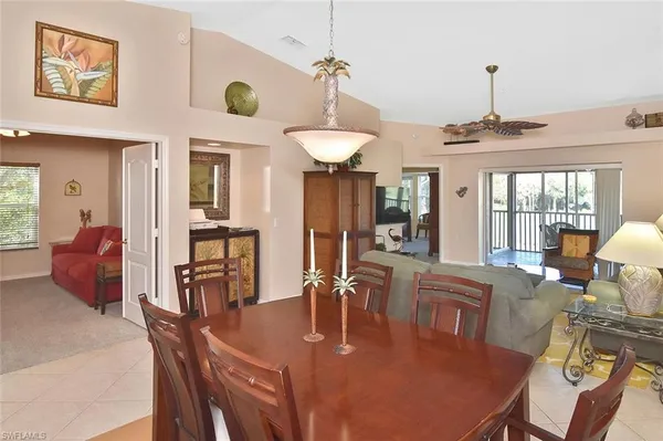 a dining room with furniture a chandelier and window