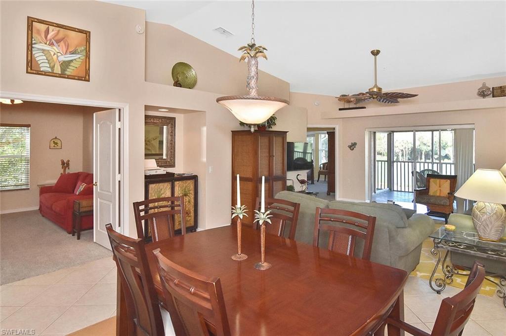 3870 Sawgrass Way, Unit 2521 Naples, FL 34112 - Photo 27 of 46 a dining room with furniture a chandelier and window