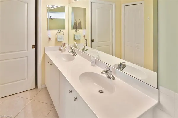a bathroom with a double vanity sink and a mirror