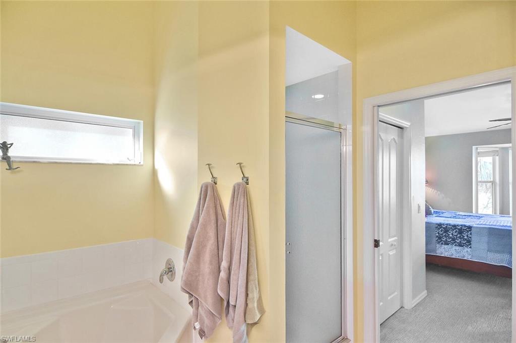 3870 Sawgrass Way, Unit 2521 Naples, FL 34112 - Photo 37 of 46 a bathroom with a sink and a mirror