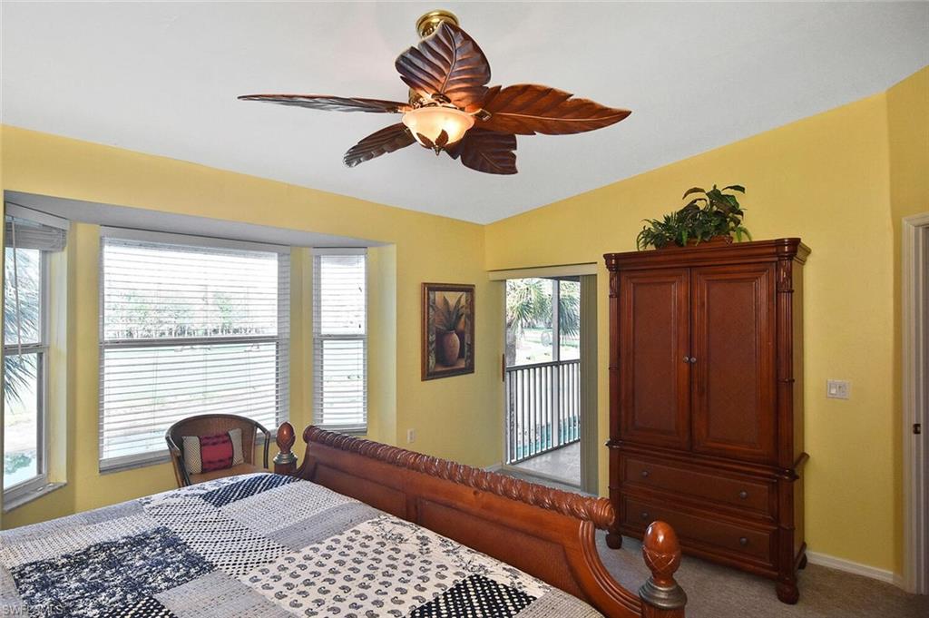 3870 Sawgrass Way, Unit 2521 Naples, FL 34112 - Photo 38 of 46 a bedroom with a bed and wooden floor