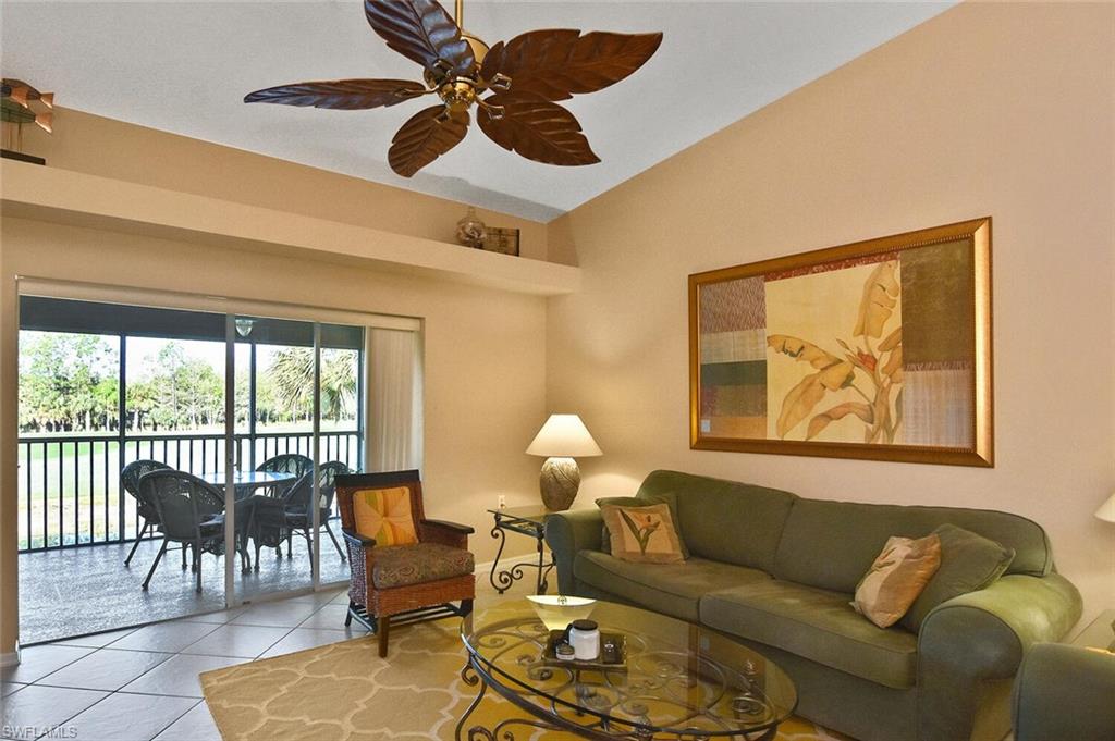 3870 Sawgrass Way, Unit 2521 Naples, FL 34112 - Photo 39 of 46 a living room with furniture and a large window