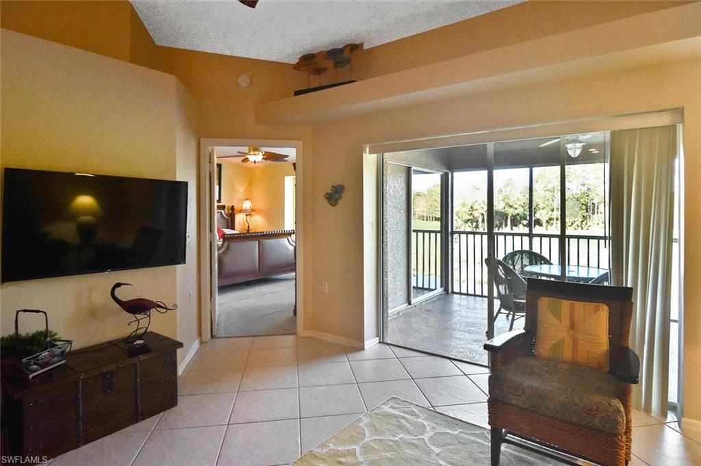 3870 Sawgrass Way, Unit 2521 Naples, FL 34112 - Photo 40 of 46 a living room with furniture and a flat screen tv