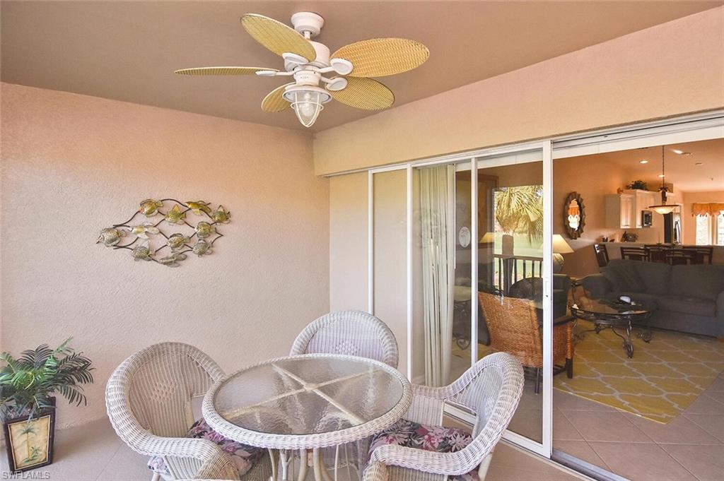 3870 Sawgrass Way, Unit 2521 Naples, FL 34112 - Photo 42 of 46 a dining room with furniture and wooden floor