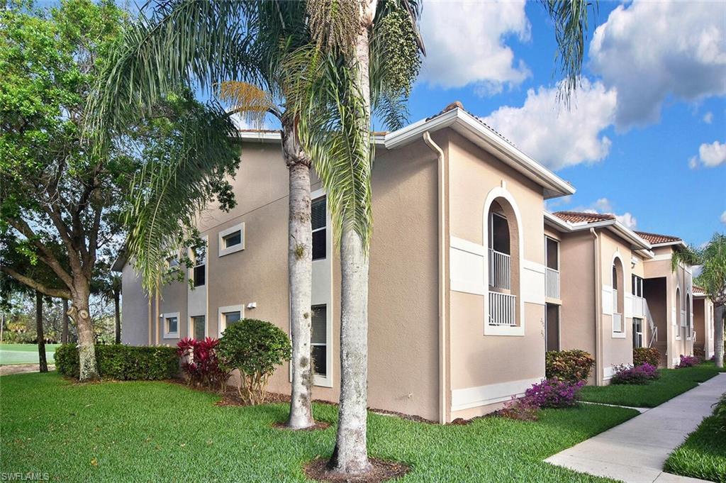 3870 Sawgrass Way, Unit 2521 Naples, FL 34112 - Photo 5 of 46 a view of white house with a yard and potted plants