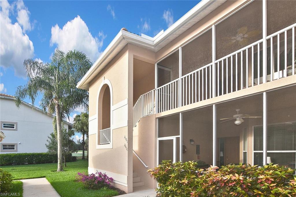 3870 Sawgrass Way, Unit 2521 Naples, FL 34112 - Photo 6 of 46 a front view of a house with garden