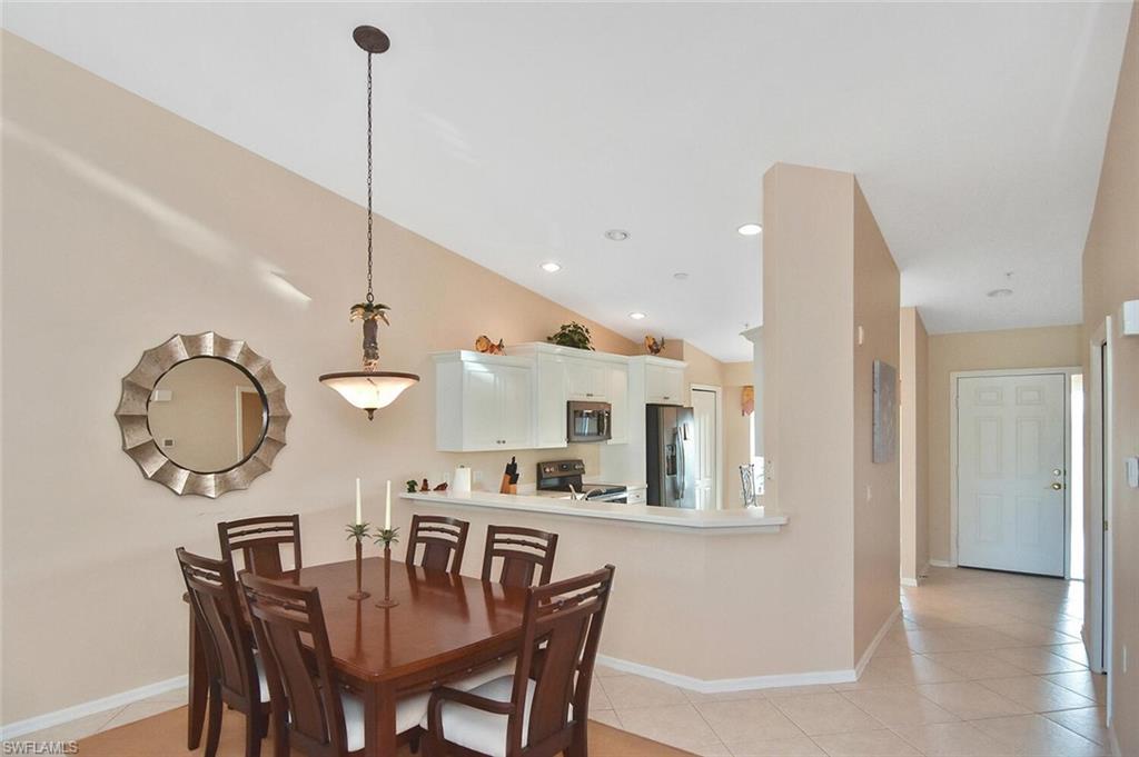 3870 Sawgrass Way, Unit 2521 Naples, FL 34112 - Photo 10 of 46 a view of a dining room and chandelier
