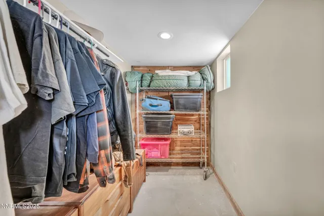 a view of walk in closet with clothes
