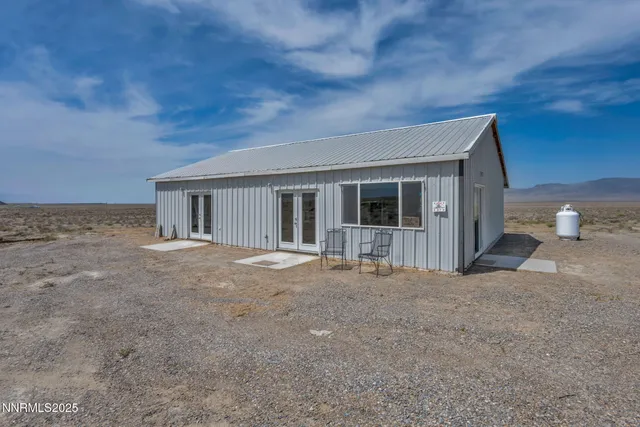 a view of house with backyard and glass door