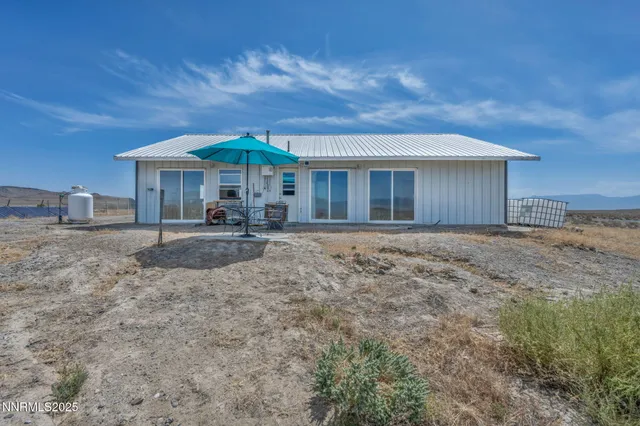 a backyard of a house with yard and outdoor seating