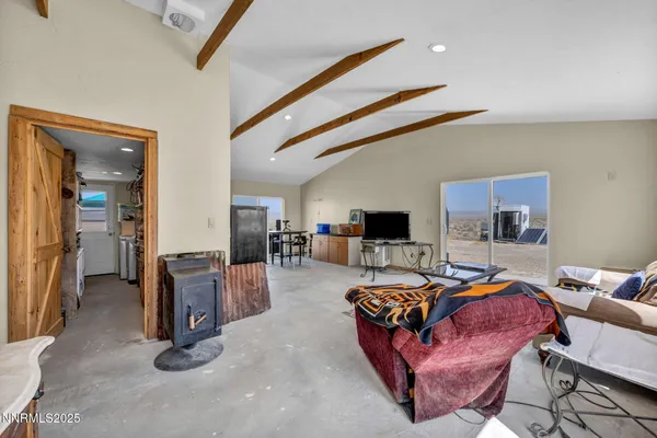 a bedroom with furniture and a flat screen tv