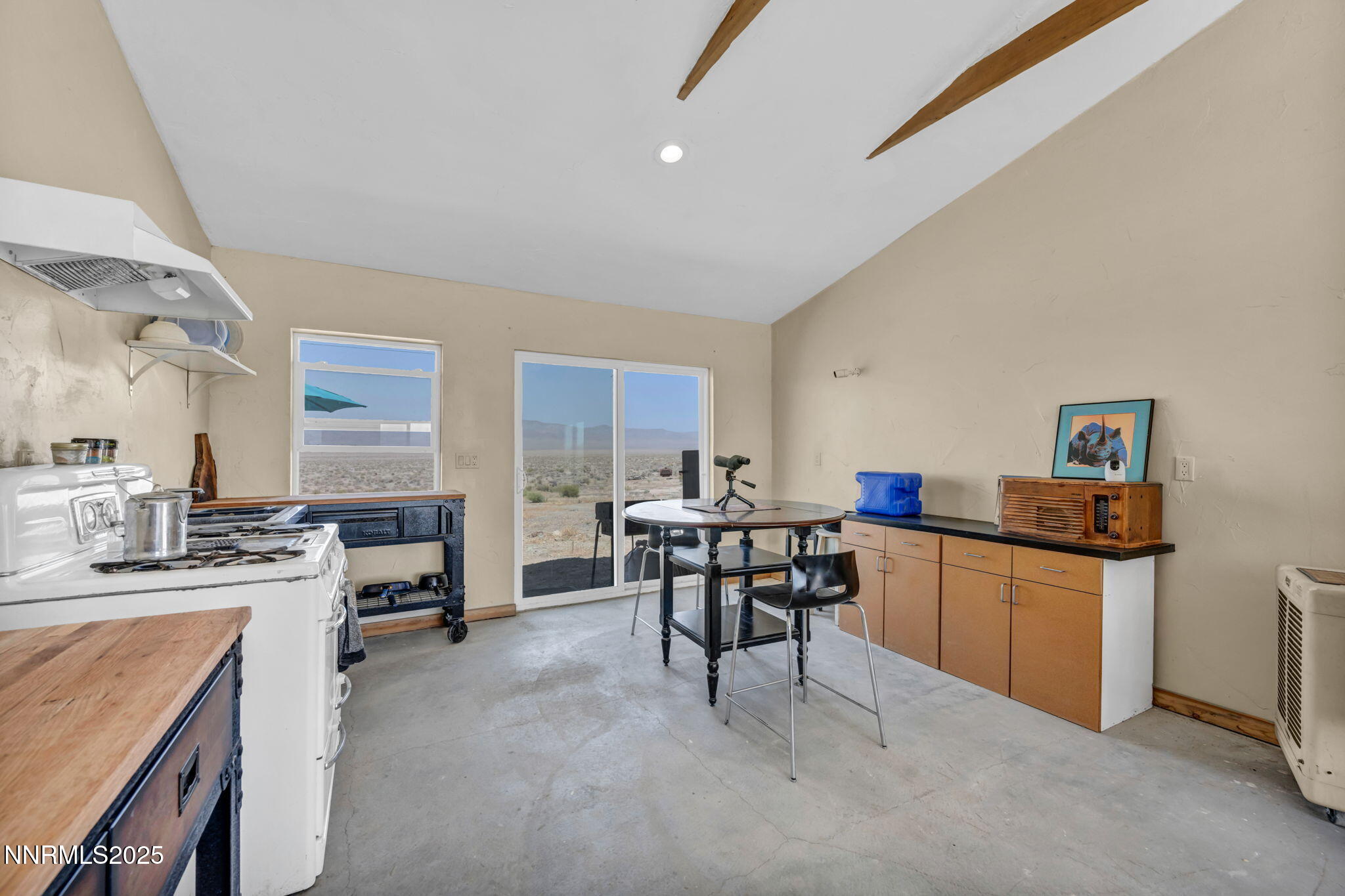14995 Coal Canyon Road Lovelock, NV 89419 - Photo 7 of 37 a kitchen with kitchen island a dining table chairs stainless steel appliances and cabinets