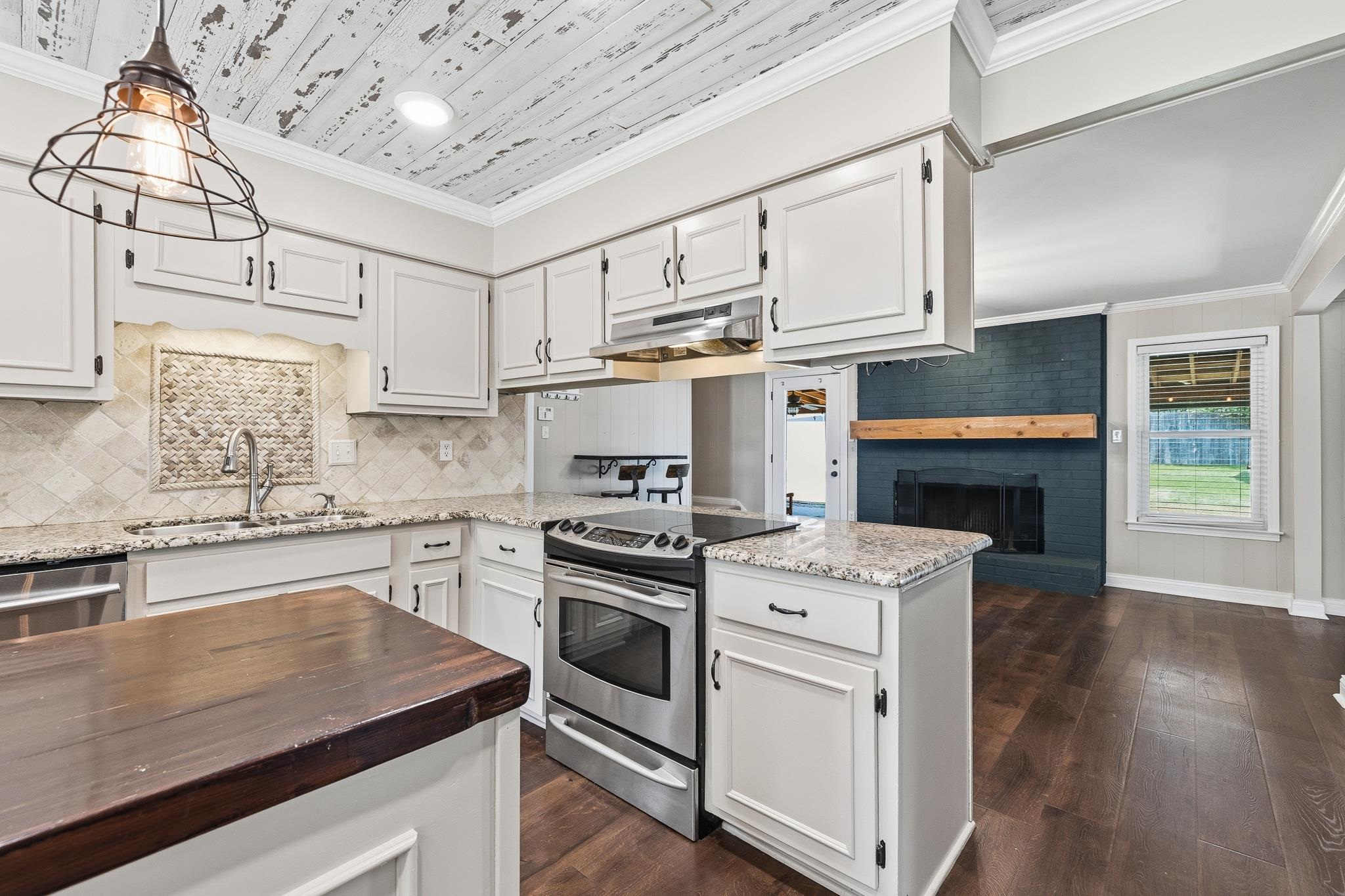 1234 Greenview Road Collierville, TN 38017 - Photo 14 of 33 a kitchen with cabinets wooden floor and stainless steel appliances