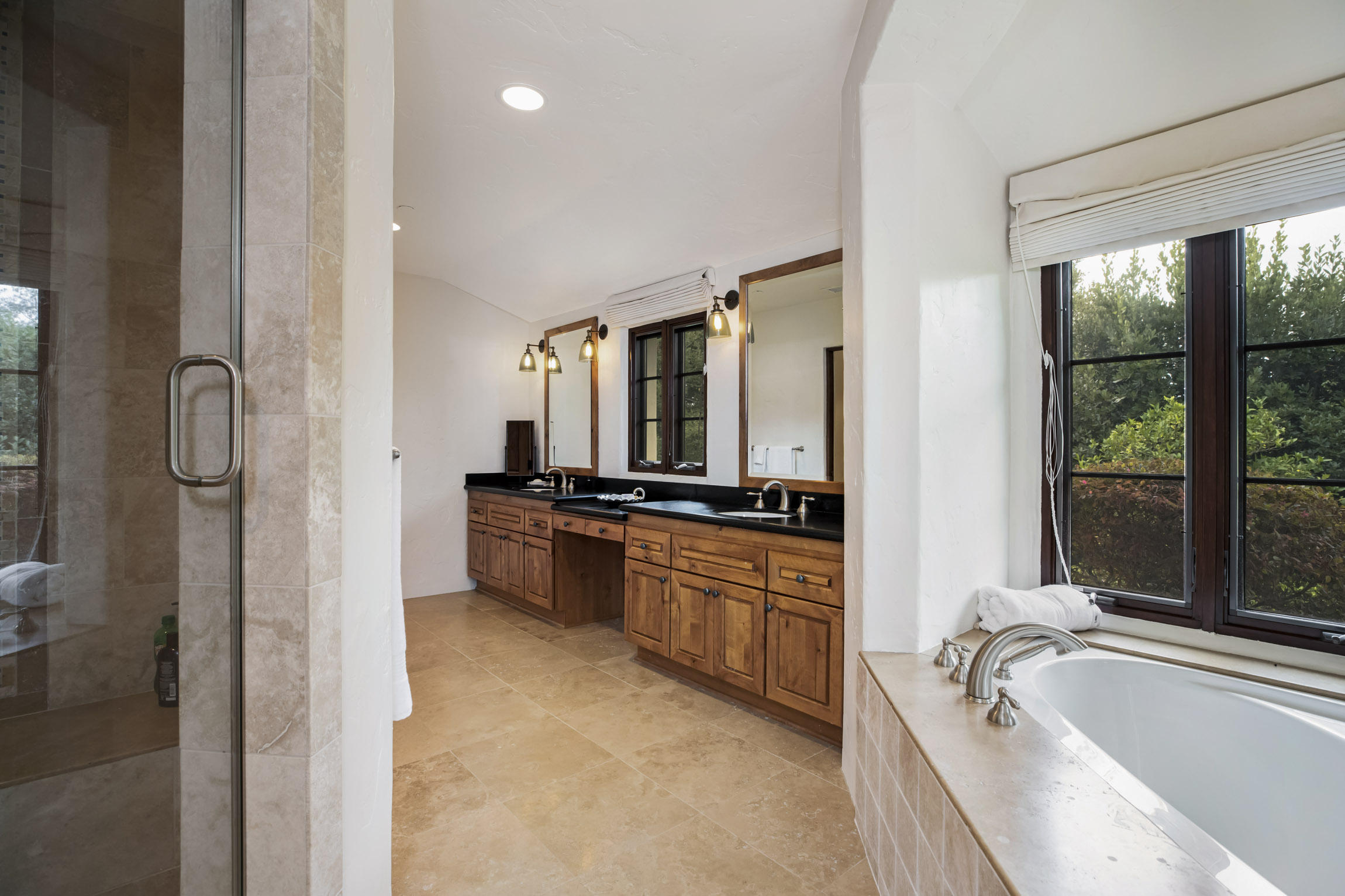 615 Hot Springs Road Montecito, CA 93108 - Photo 17 of 23 a large bathroom with a tub a sink a mirror and a shower