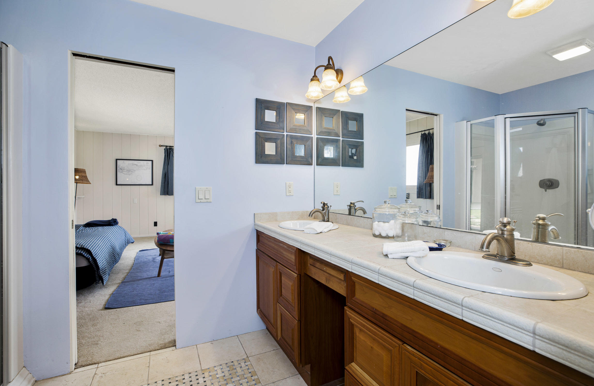 615 Hot Springs Road Montecito, CA 93108 - Photo 21 of 23 a en suite bathroom with a double vanity sink and a mirror