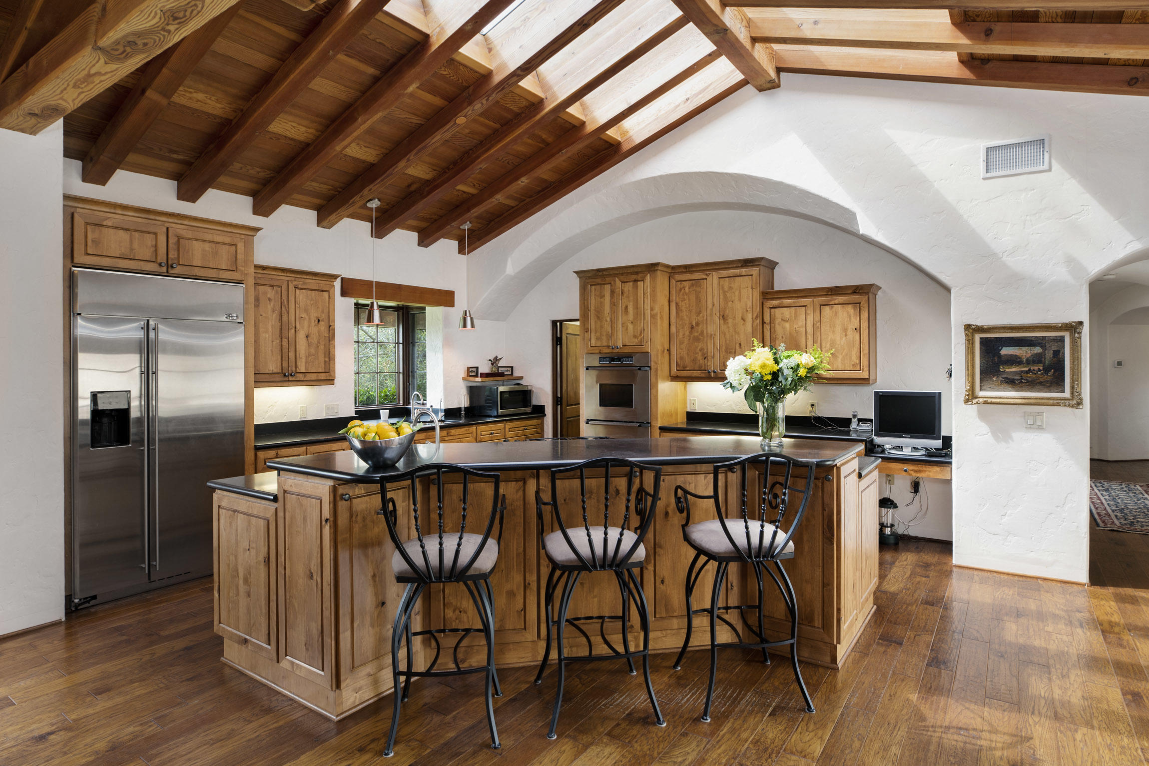 615 Hot Springs Road Montecito, CA 93108 - Photo 6 of 23 a kitchen with stainless steel appliances a dining table chairs and wooden floor