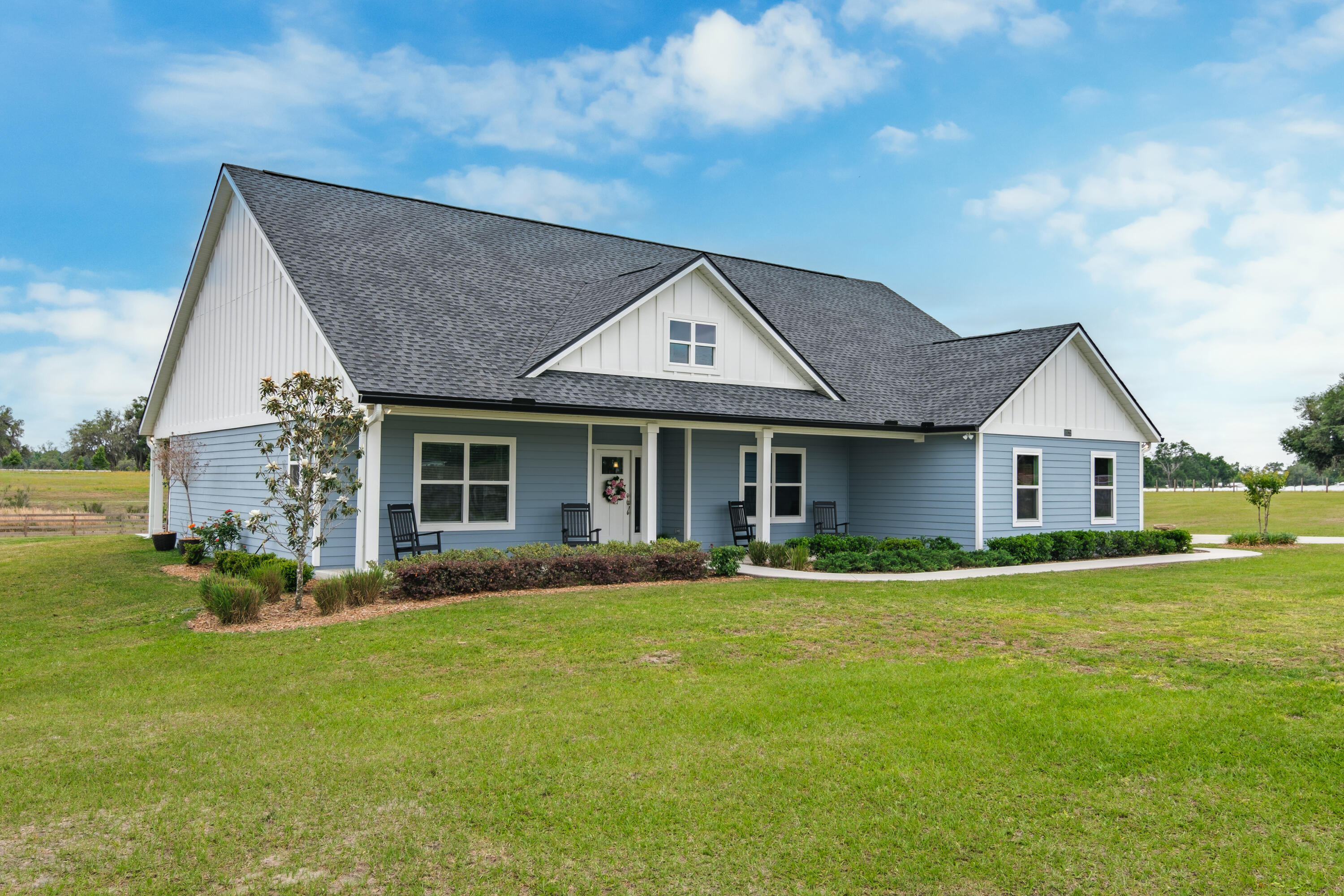 10172 98th Street, Unit 2 Live Oak, FL 32060 - Photo 1 of 37 a front view of a house with a garden and porch