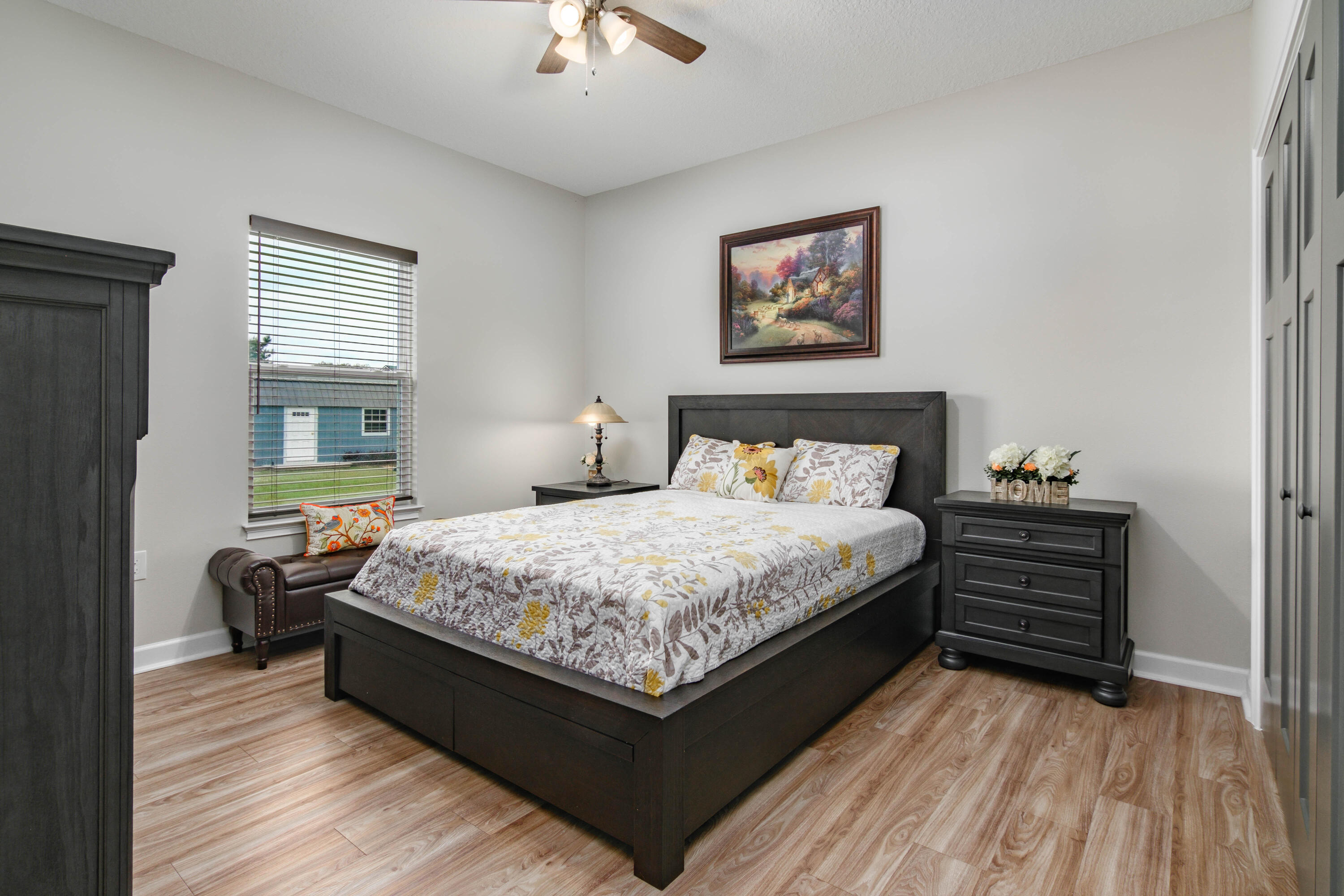 10172 98th Street, Unit 2 Live Oak, FL 32060 - Photo 30 of 37 a bedroom with a bed and wooden floor