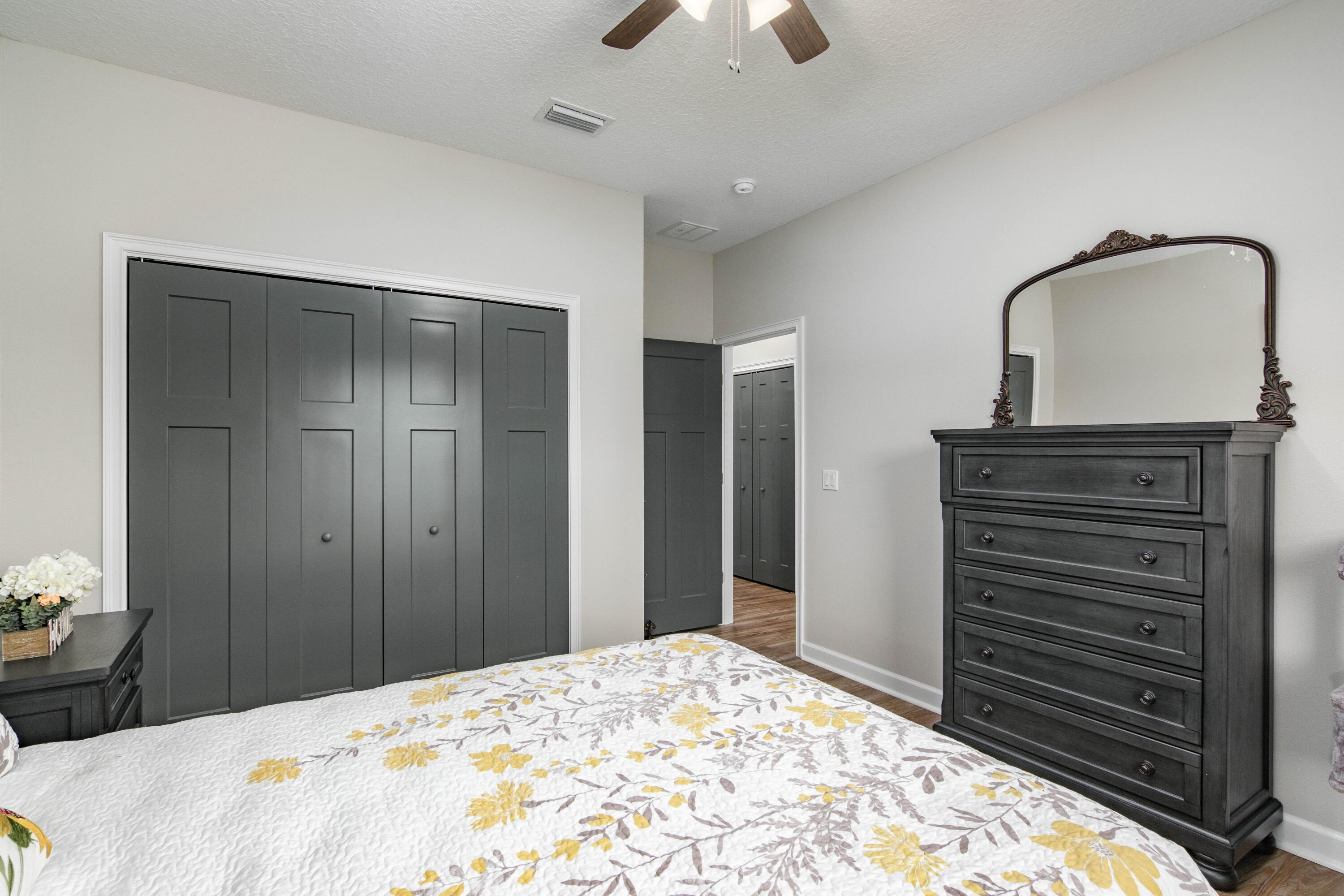 10172 98th Street, Unit 2 Live Oak, FL 32060 - Photo 31 of 37 a bedroom with a bed and a dresser