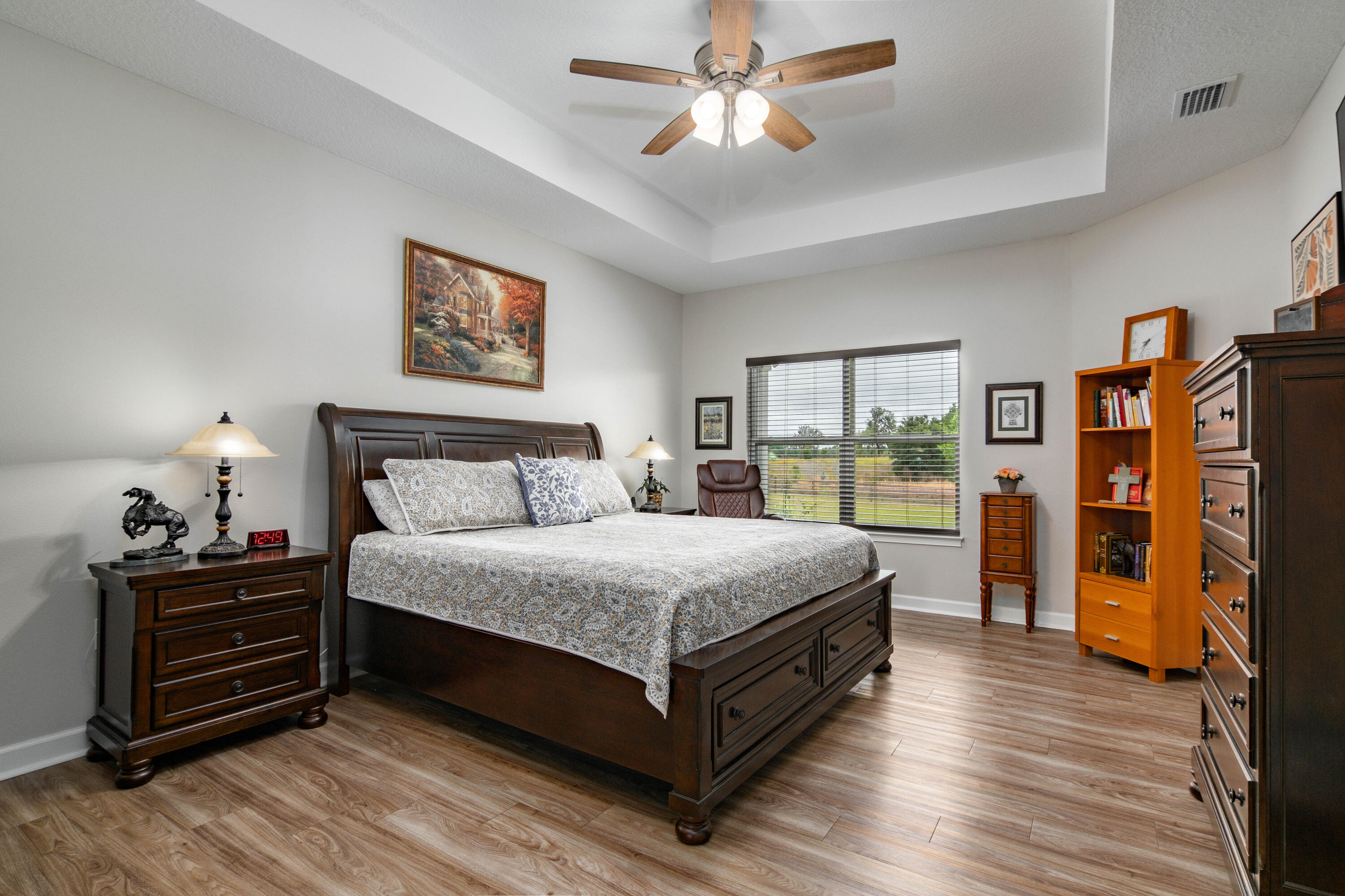 10172 98th Street, Unit 2 Live Oak, FL 32060 - Photo 5 of 37 a spacious bedroom with a bed and a chandelier