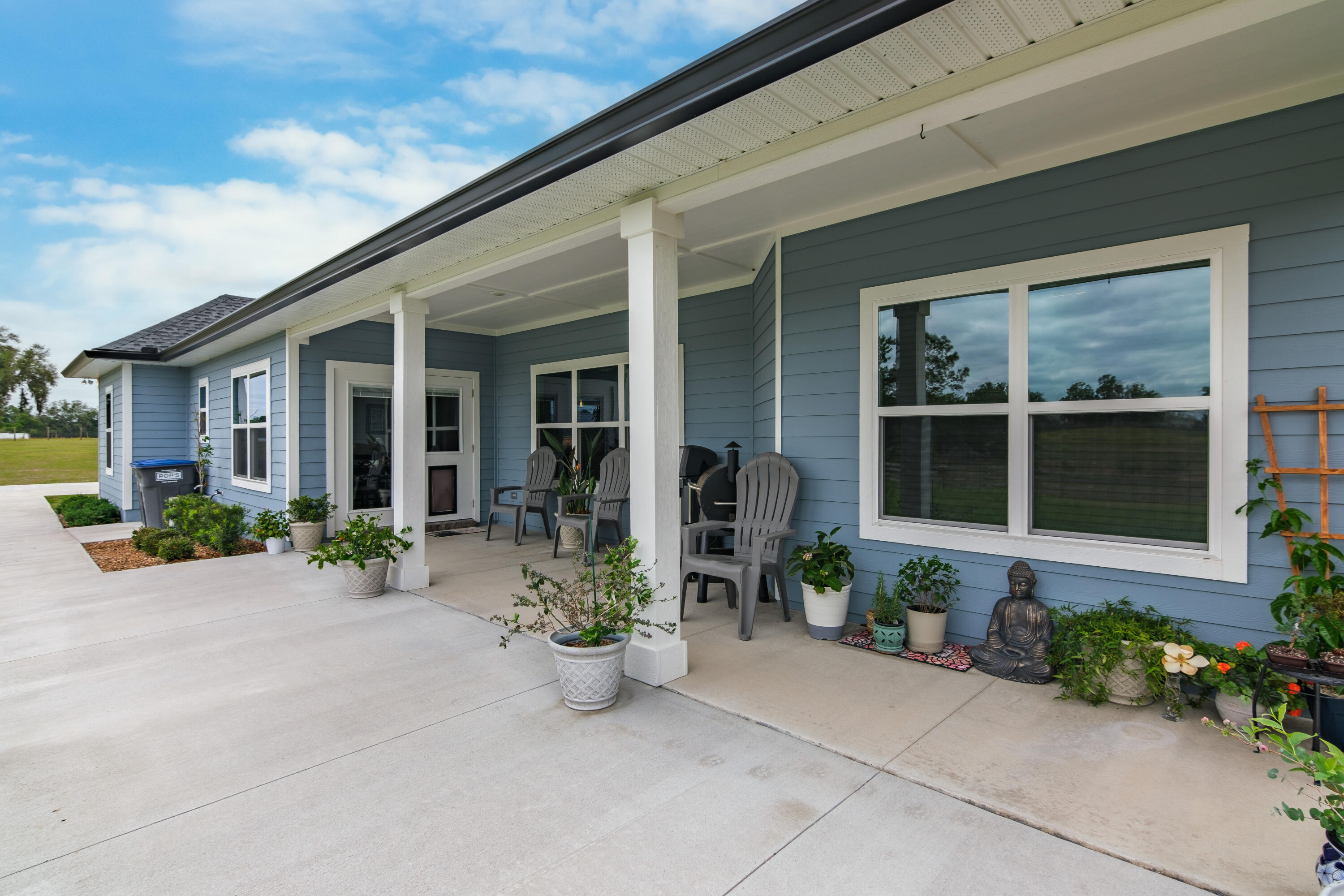 10172 98th Street, Unit 2 Live Oak, FL 32060 - Photo 10 of 37 front view of a house with potted plants