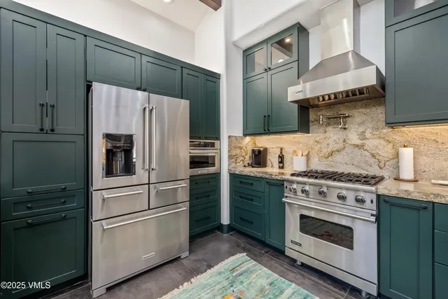 a kitchen with stainless steel appliances and white cabinets