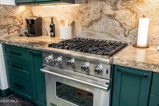 a stove top oven sitting inside of a kitchen