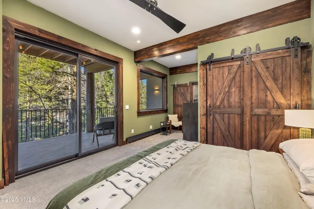 a bedroom with a bed and large window