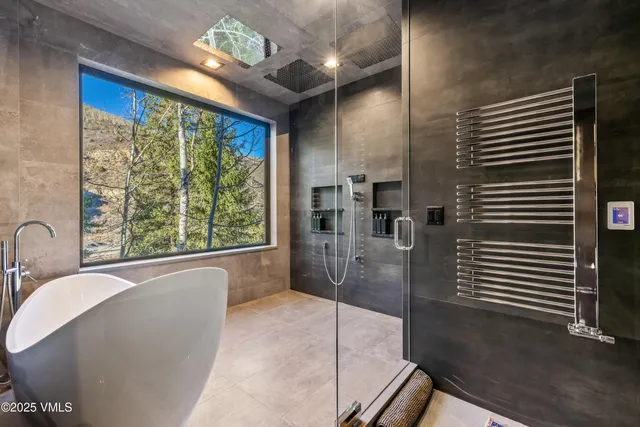 a large bathroom with a large tub and shower