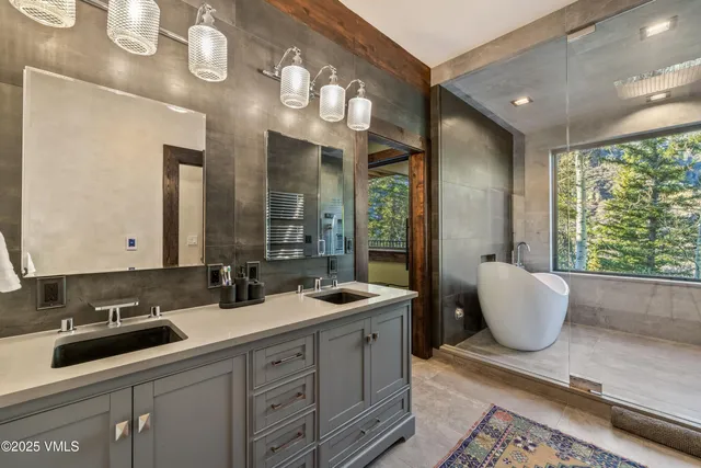 a bathroom with a double vanity sink and a mirror