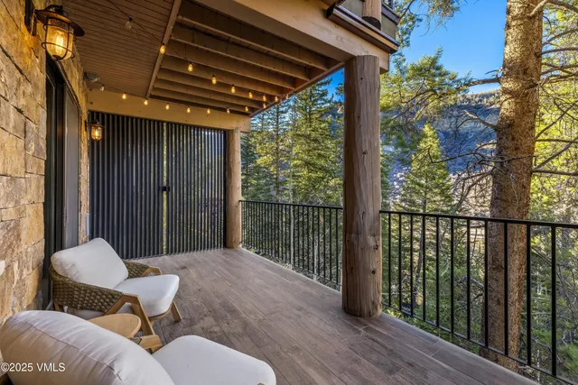 a balcony view with a large window and wooden floor