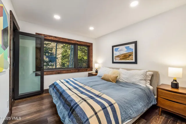 a bedroom with a large bed and a large window