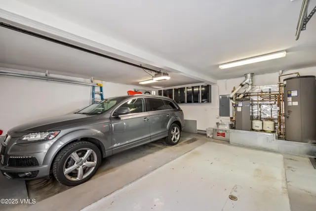 a view of a lush green field with mountains in the background