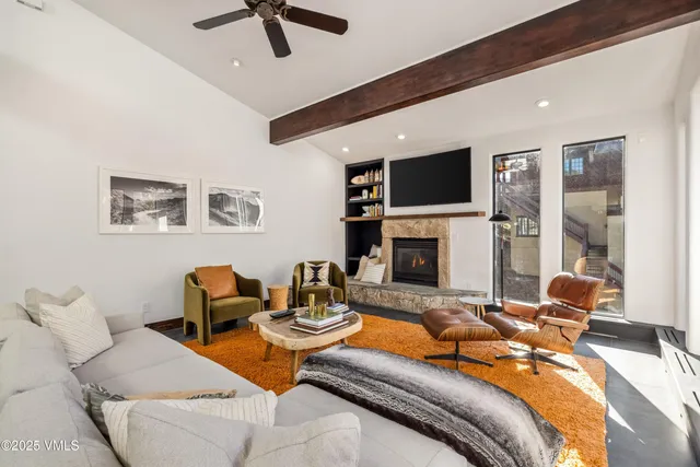 a living room with furniture fireplace and a flat screen tv