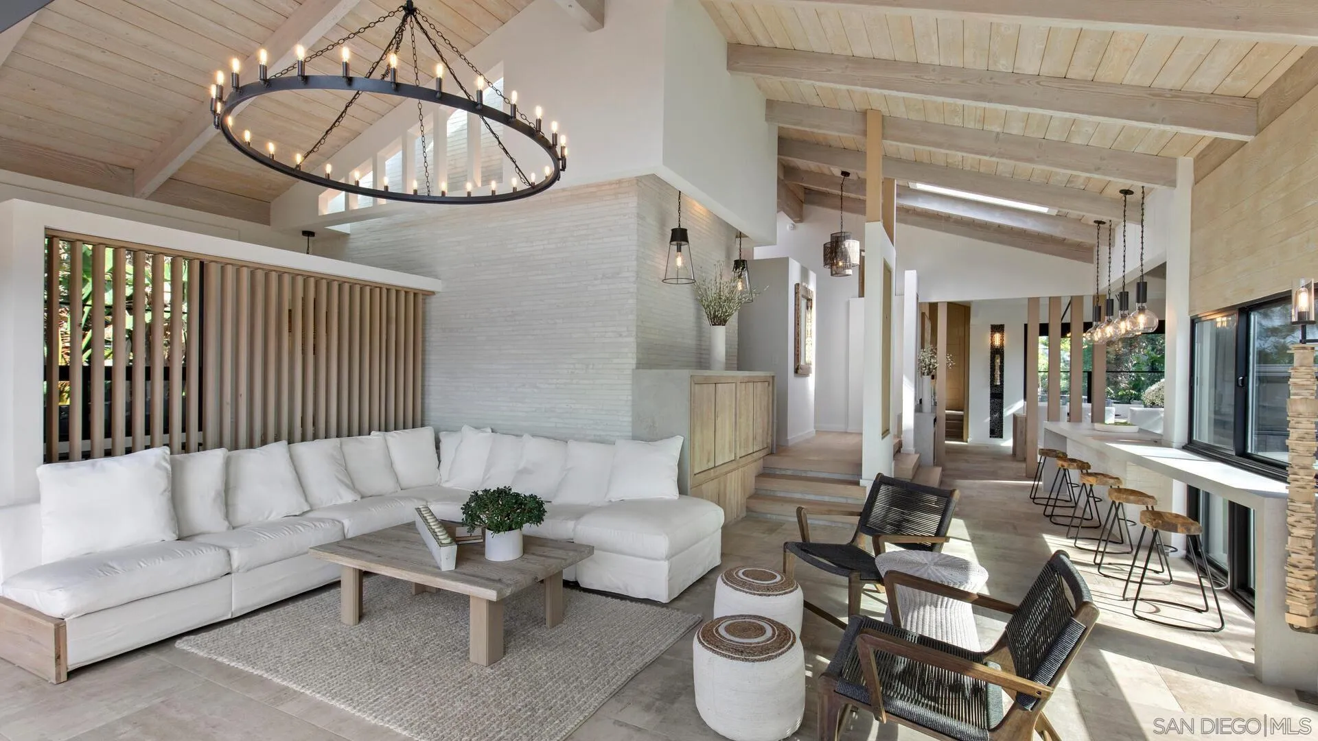 a living room with furniture a table and wooden floor