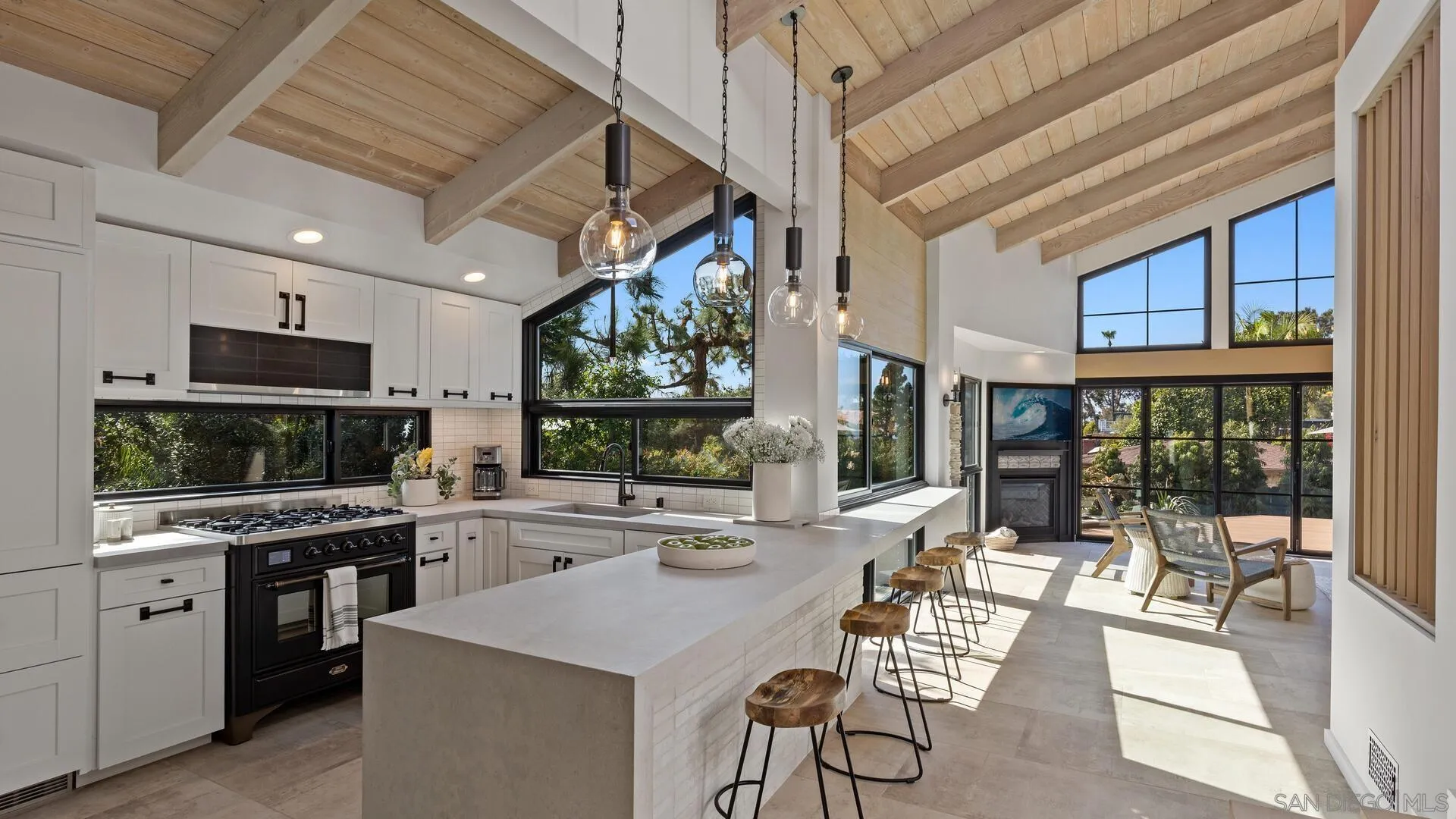 340 7th Street Del Mar, CA 92014 - Photo 2 of 30 a kitchen with stainless steel appliances kitchen island granite countertop a stove and white cabinets