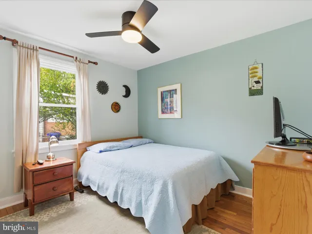 a bedroom with a bed dresser and a window