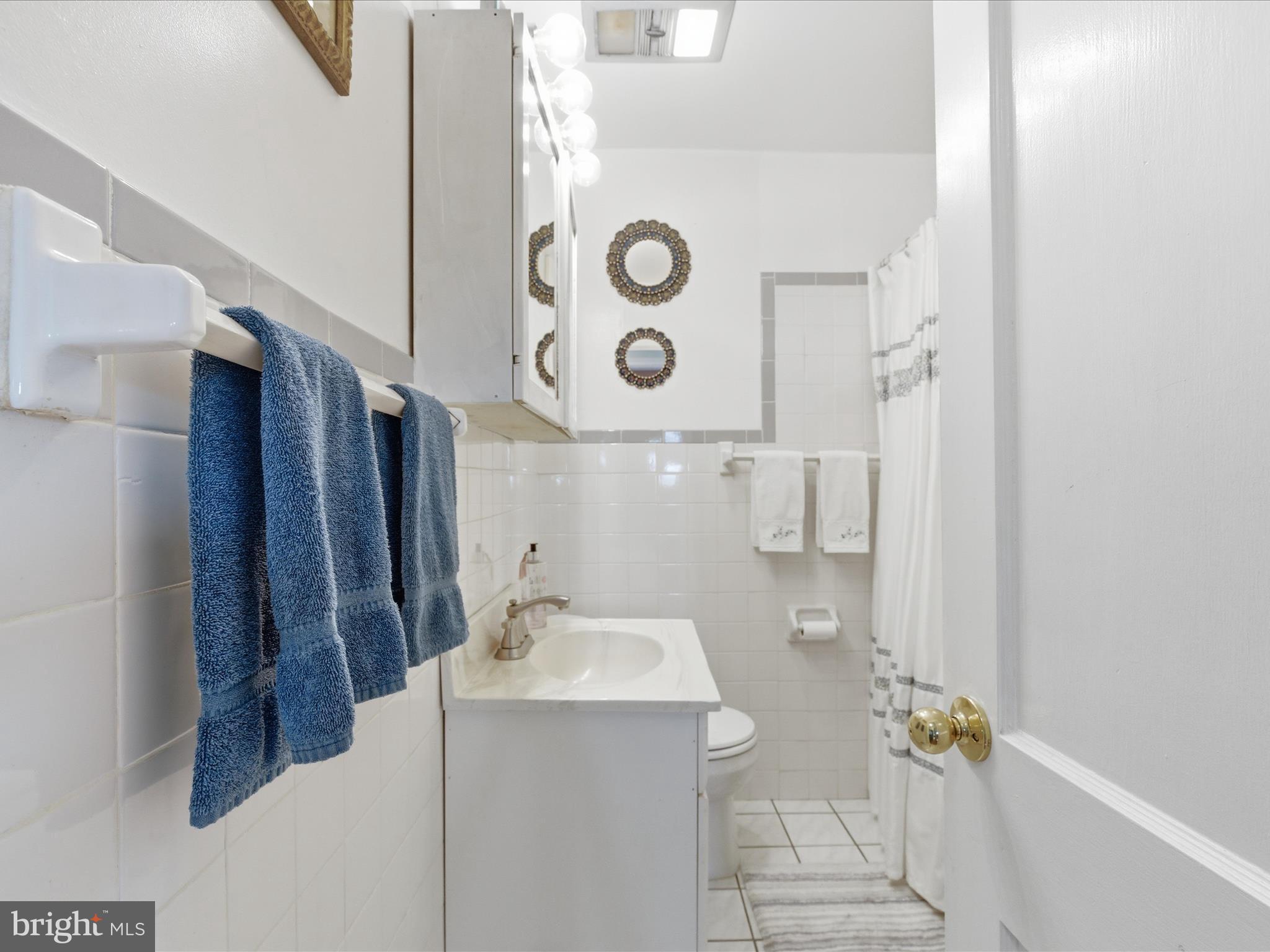 2707 Lindell Street Silver Spring, MD 20902 - Photo 23 of 51 a bathroom with a sink and mirror with shower