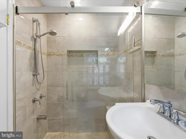 a bathroom with a sink and shower
