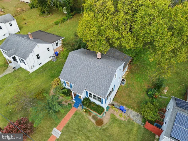 an aerial view of a house with a yard
