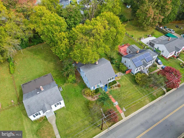an aerial view of a house with garden space and street view