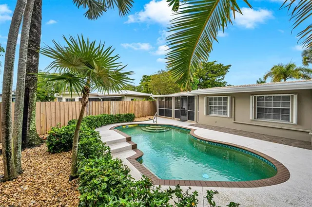 a view of a house with swimming pool and sitting area