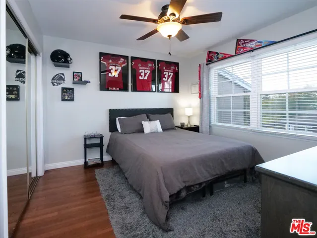 a bedroom with a bed and a large window with the outer view