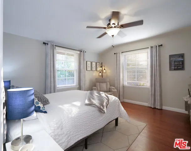 a bed sitting in a bedroom next to a window