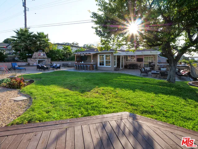 a view of backyard with garden and outdoor seating