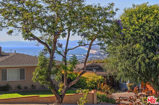 a view of swimming pool with a yard and plants
