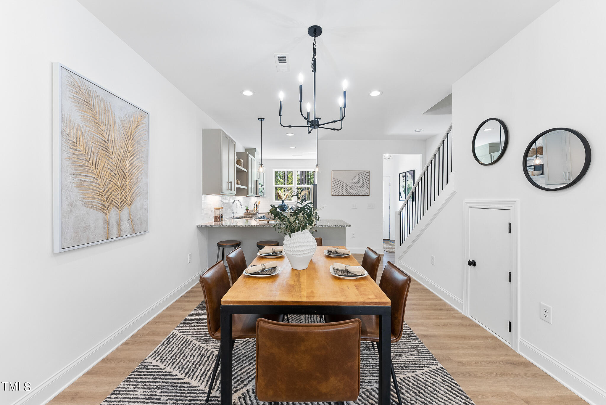 4811 Gossamer Lane, Unit 102 Raleigh, NC 27616 - Photo 14 of 46 a view of a dining room with furniture and a chandelier