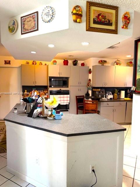 13041 Southwest 260th Terrace Homestead, FL 33032 - Photo 25 of 46 a kitchen with a sink a stove and chairs