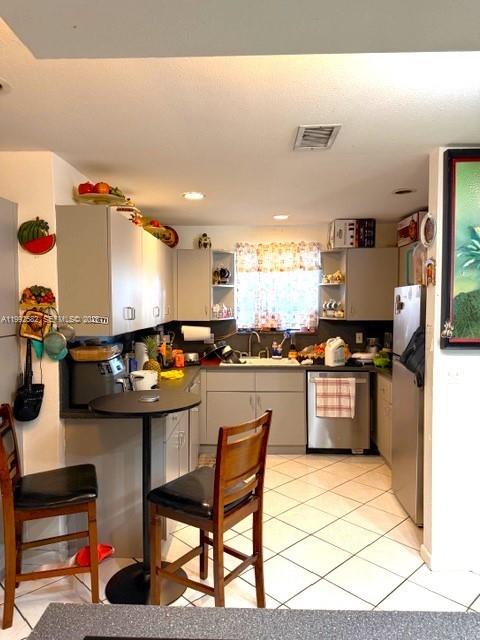 13041 Southwest 260th Terrace Homestead, FL 33032 - Photo 26 of 46 a kitchen with stainless steel appliances kitchen island granite countertop a sink and cabinets