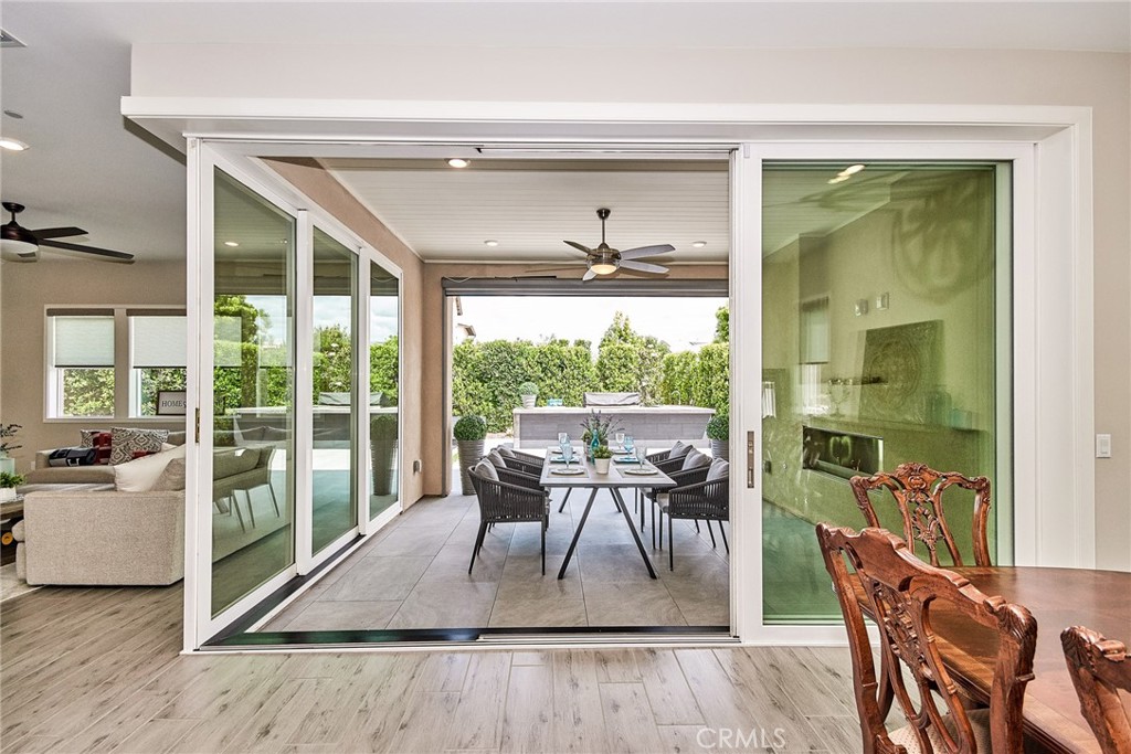115 Crossover Irvine, CA 92618 - Photo 15 of 64 a dining room with furniture large windows and wooden floor
